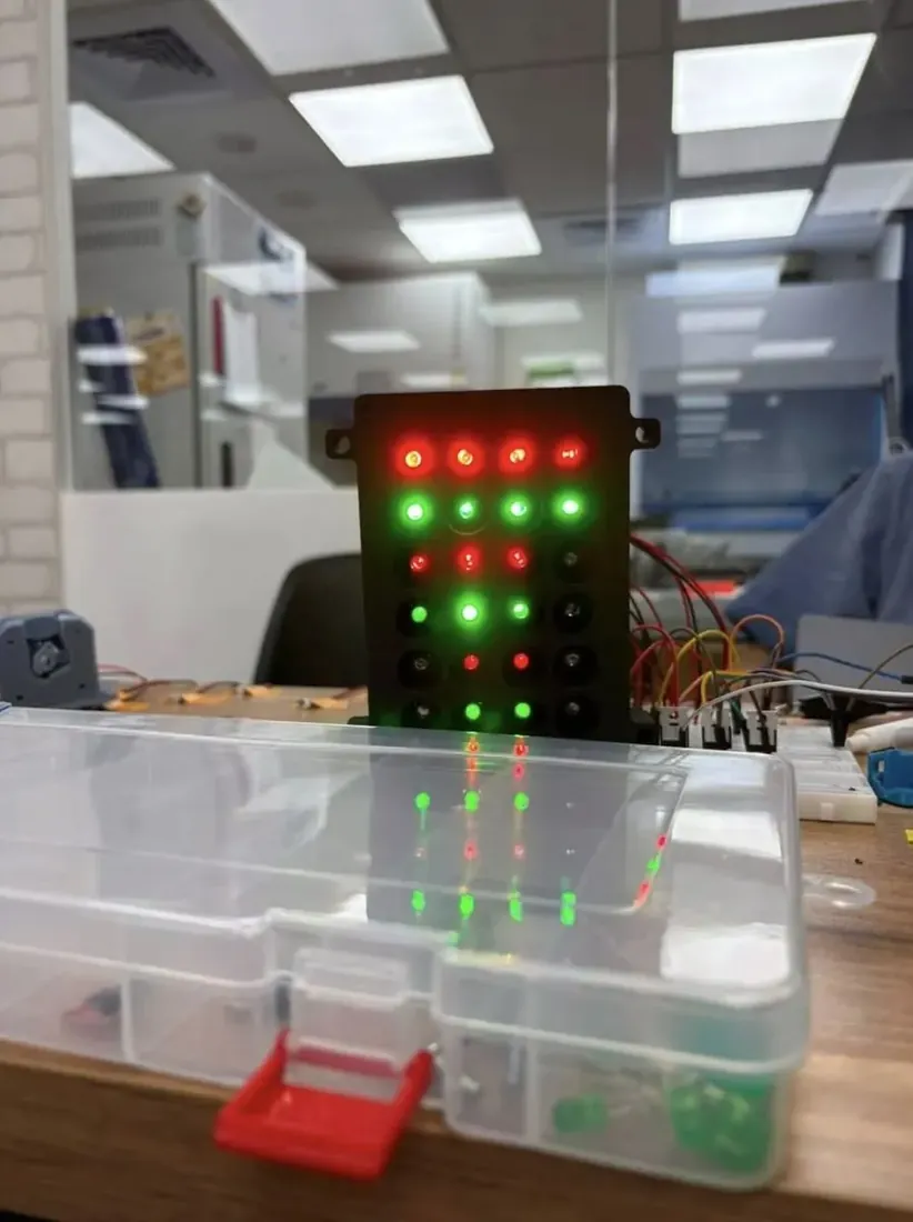 The array switched on, columns of green and red LEDs glowing above a rack of tubes.