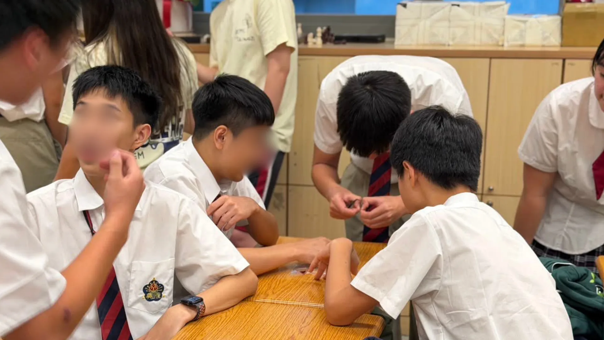 High school students peeling a thin layer of onion epidermis for the plasmolysis experiment.