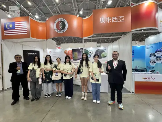 The team posed at an exhibition stand.