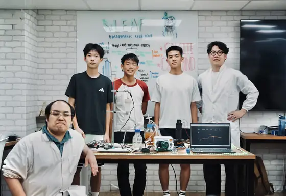 Hardware members and an instructor posed behind the bioreactor set.