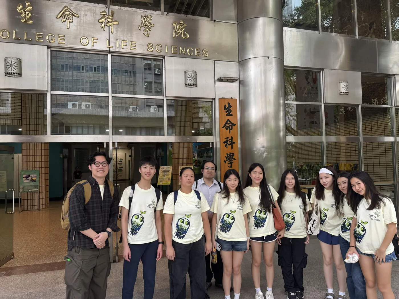 The team standing in front of the College of Life Sciences building.
