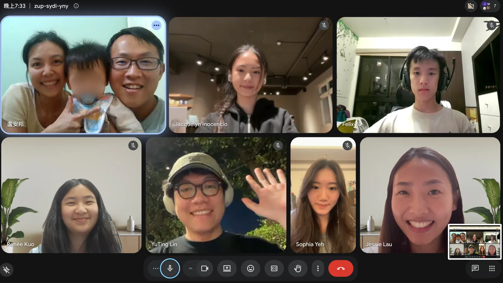 A video call grid: Mr. Lu holding a young child, with team members in the other tiles.