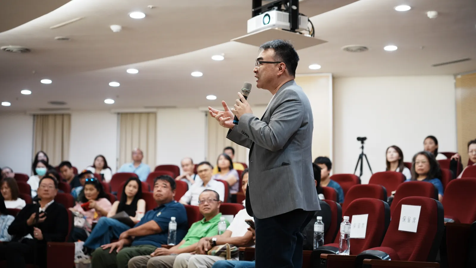 The expert from CH Biotech gesturing to the audience.