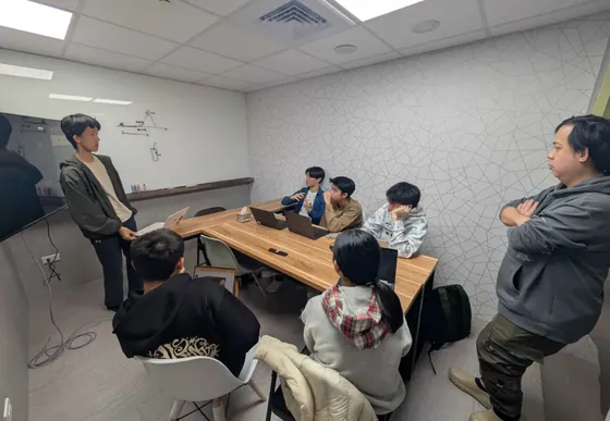 Members pitching their project proposal to advisors.