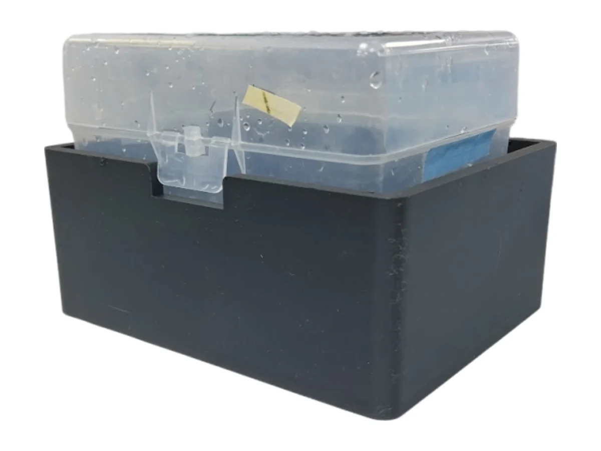 The clear hydroponic box sitting inside the black light-blocking box.