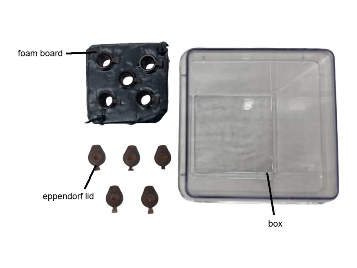 The black foam board, Eppendorf lids and the clear box laid out separately.