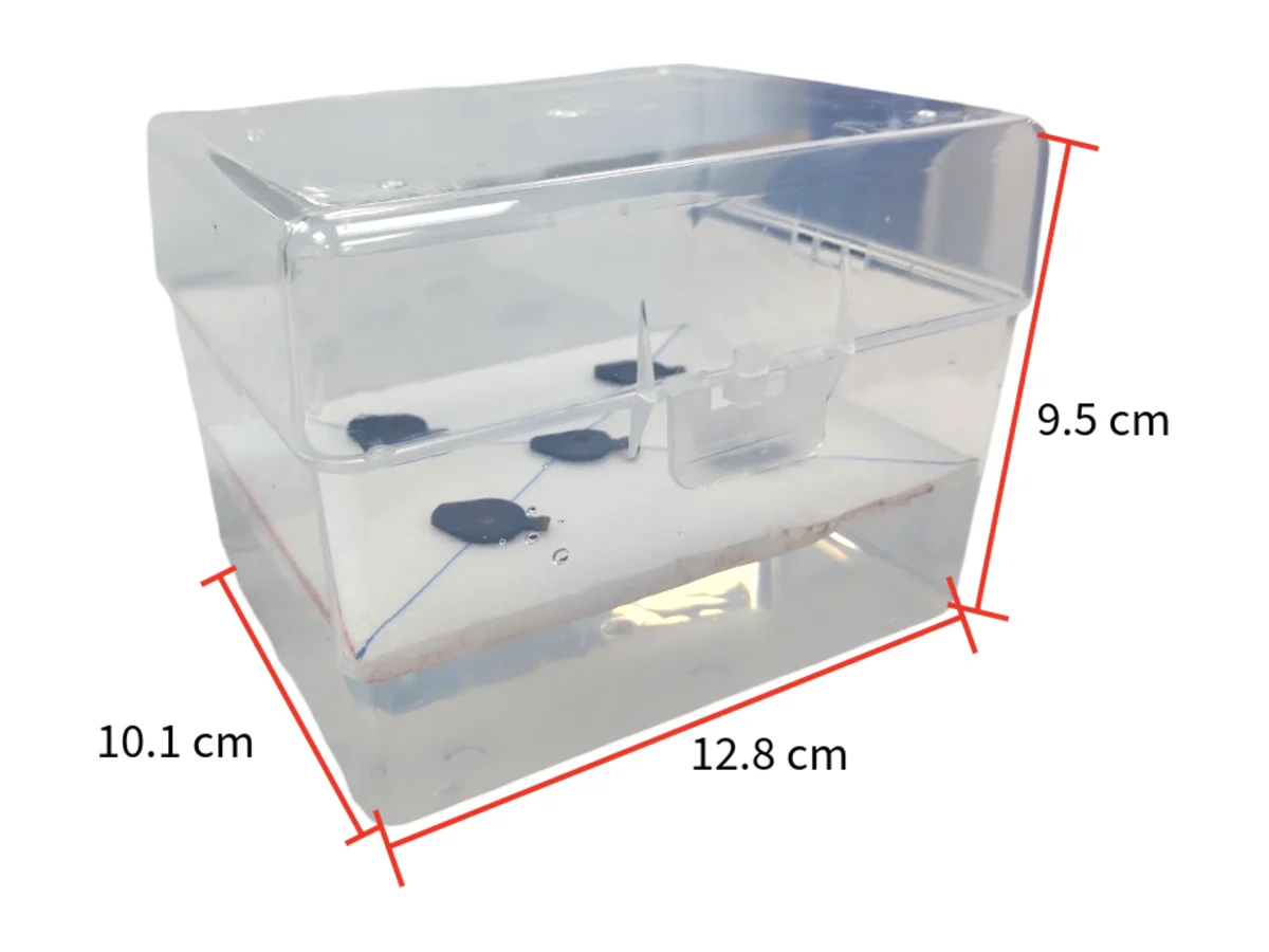 Prototype 4: a clear 1000 microlitre tip box, 12.8 by 10.1 by 9.5 centimetres, with a white foam board floating inside.