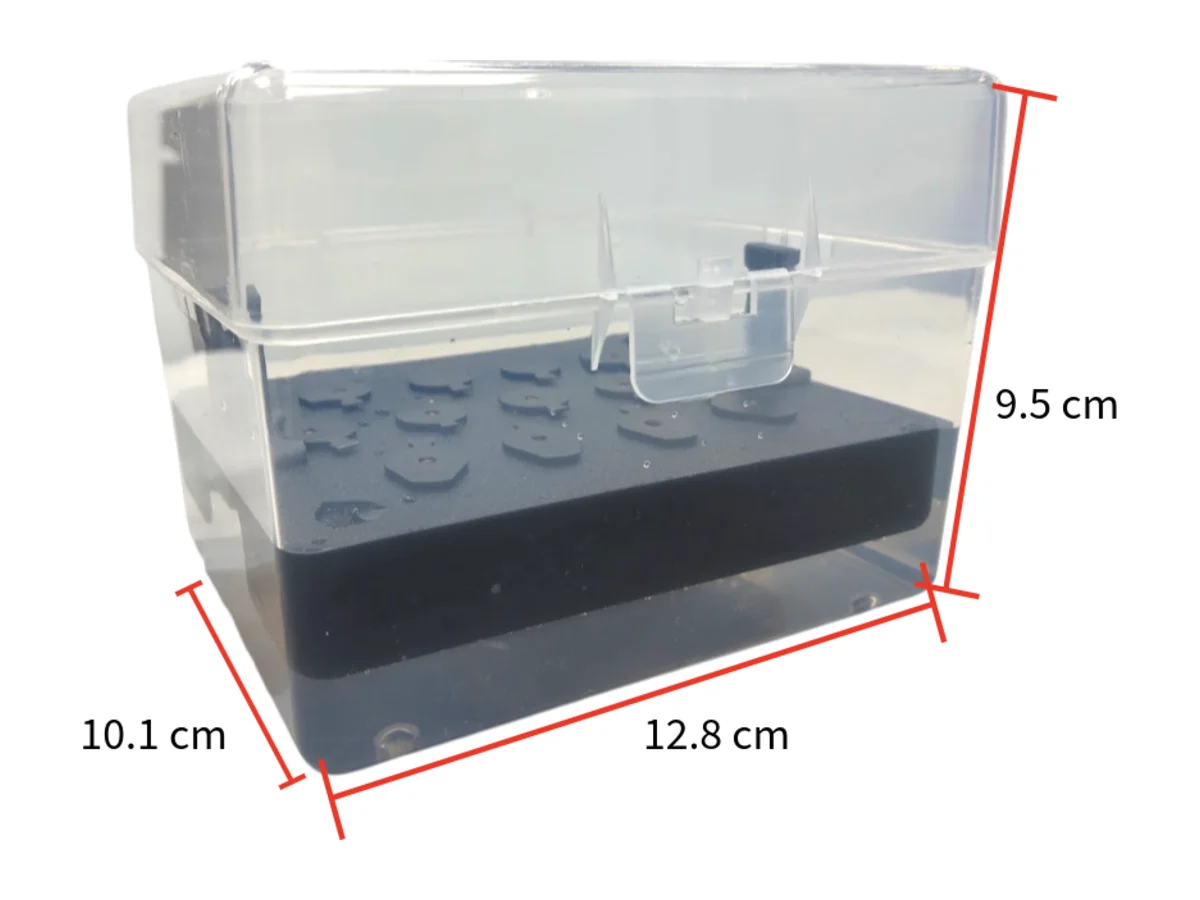 The clear tip box with a black 3D-printed float board inside.