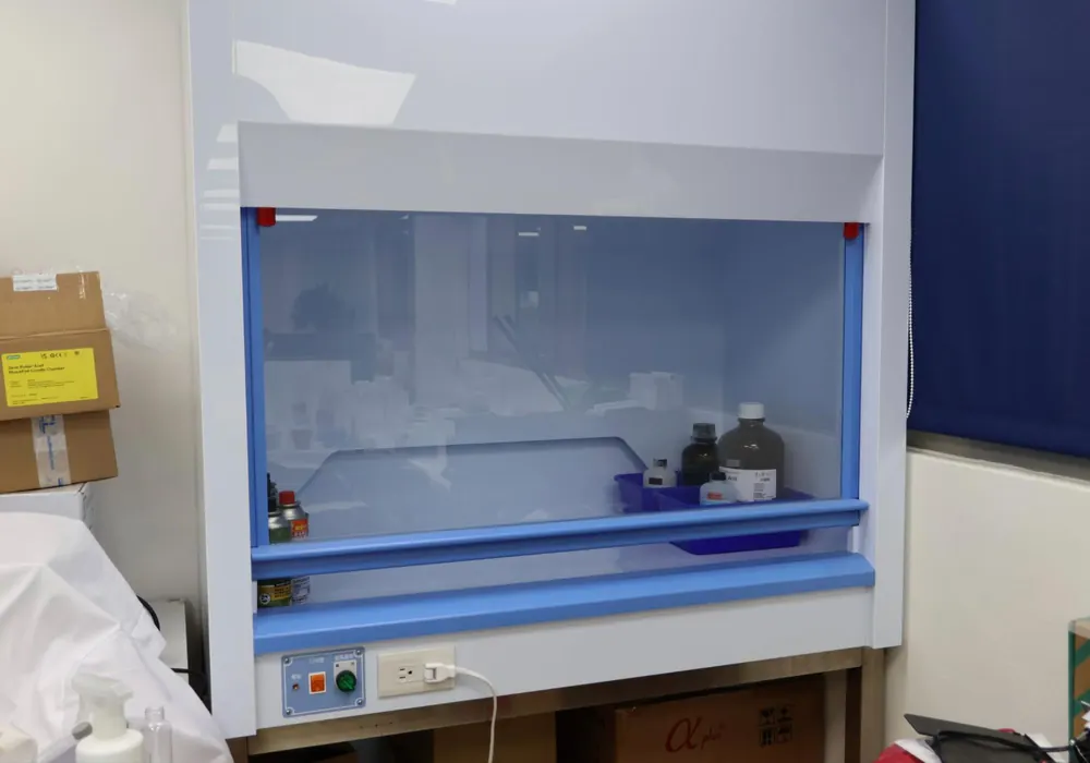 A biosafety cabinet with its sash lowered and a clean, empty work surface.
