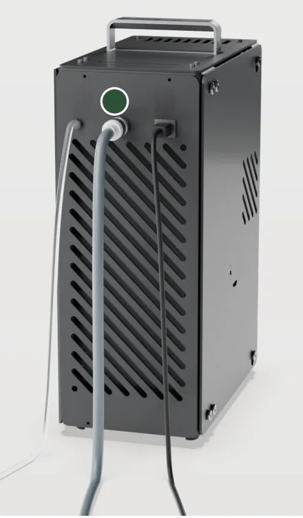 The rear of the commercial bioreactor, with three connections: the outlet line, the water inlet hose (marked) and the power cord