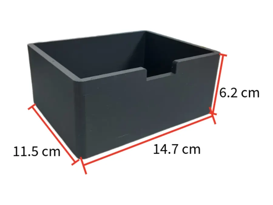 The empty black light-blocking box, 14.7 by 11.5 by 6.2 cm, with a notch cut into the top of one long side.