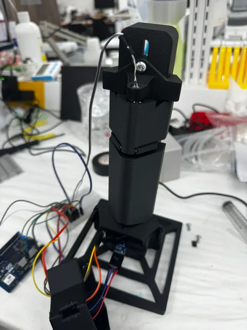 V4: an enclosed black column on its angled base, wired to the Arduino