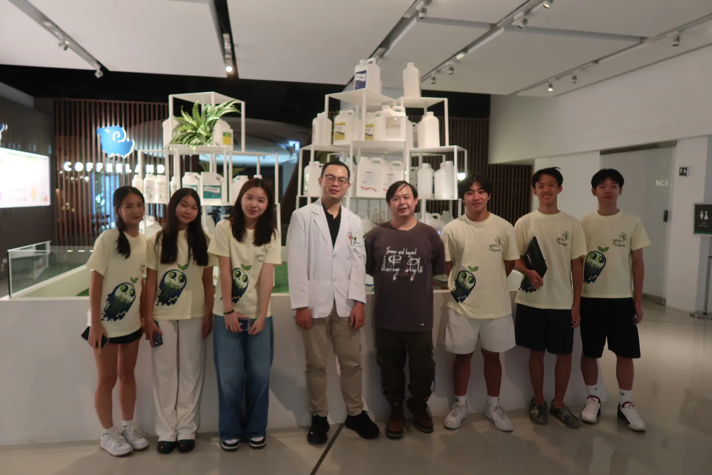 The team with two CH Biotech staff, one in a white coat, in the company showroom.