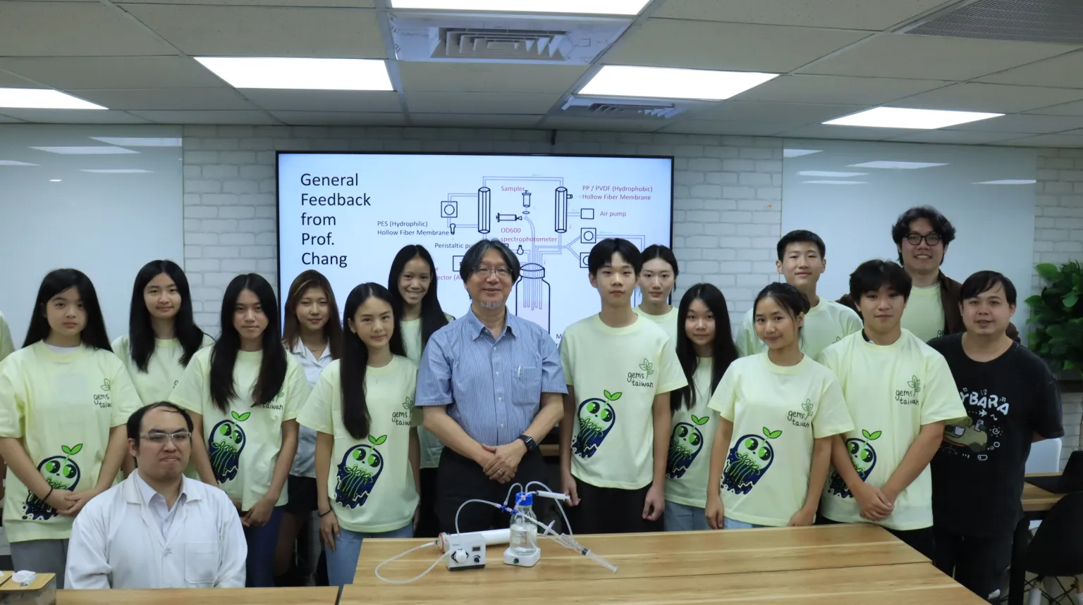 The team with Prof. Chang in front of a slide reading General Feedback from Prof. Chang.