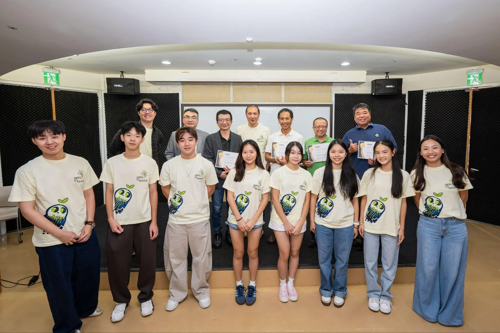 The team with forum guests on the stage.