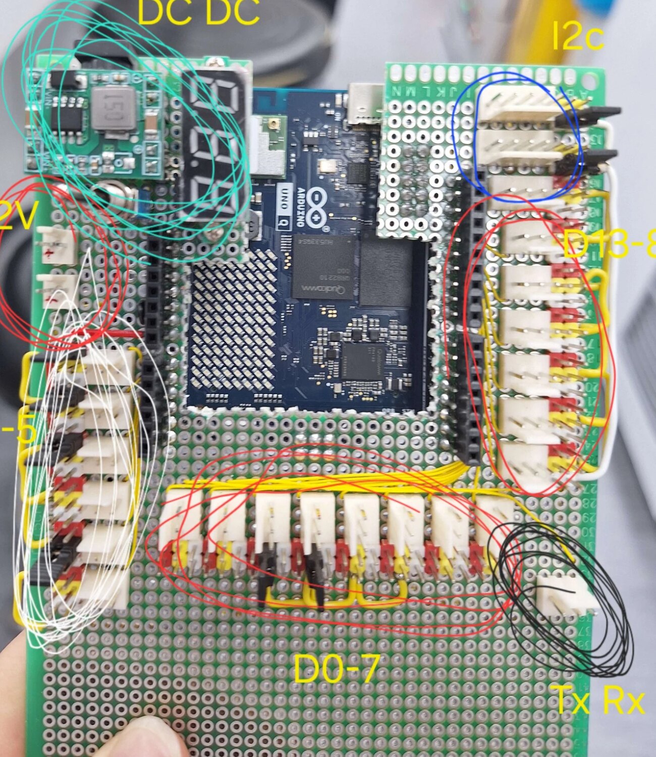 Component side of the breakout board with the UNO Q visible through the cut-out and each socket group circled and labelled